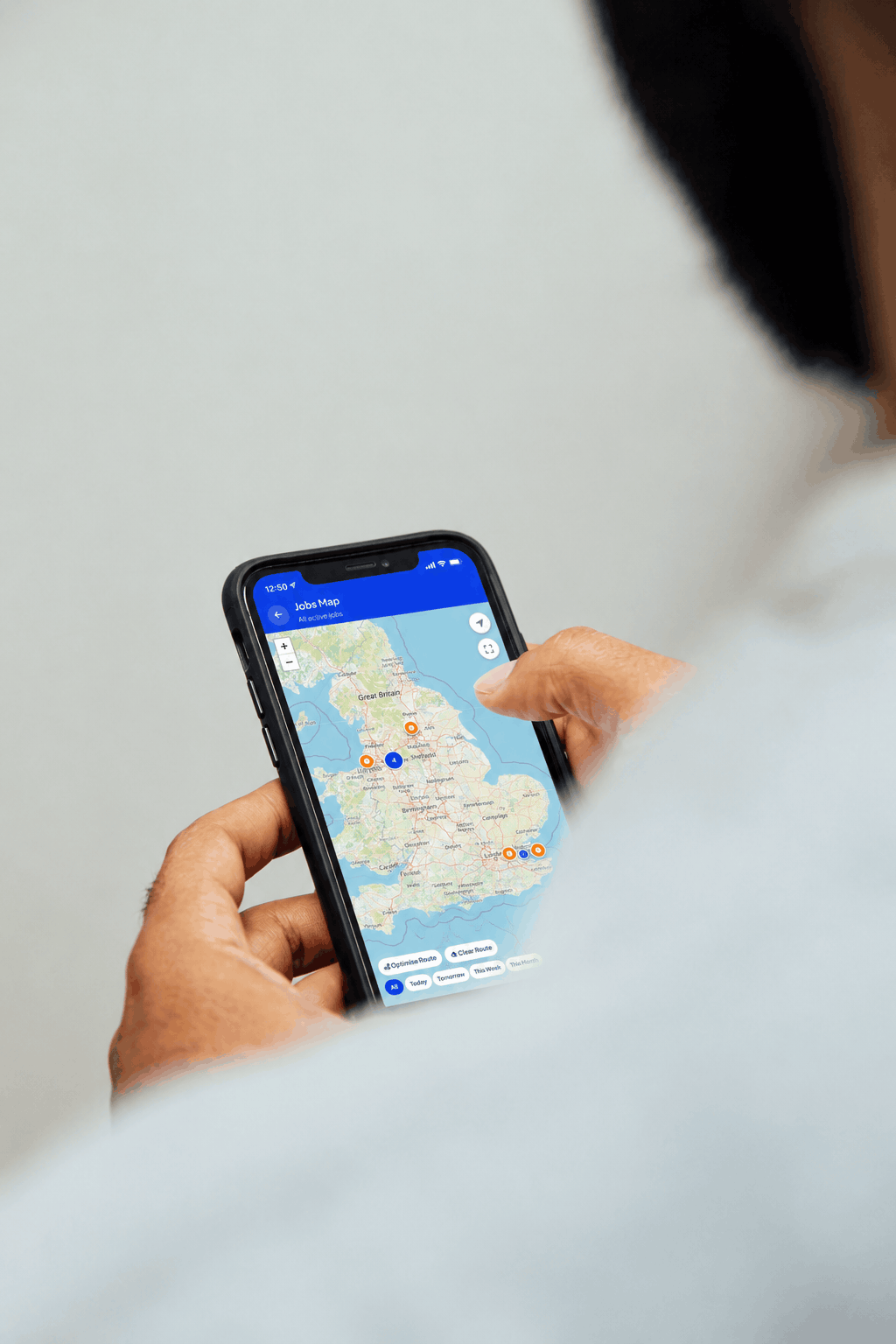 Locksmith checking a job address and map on a phone