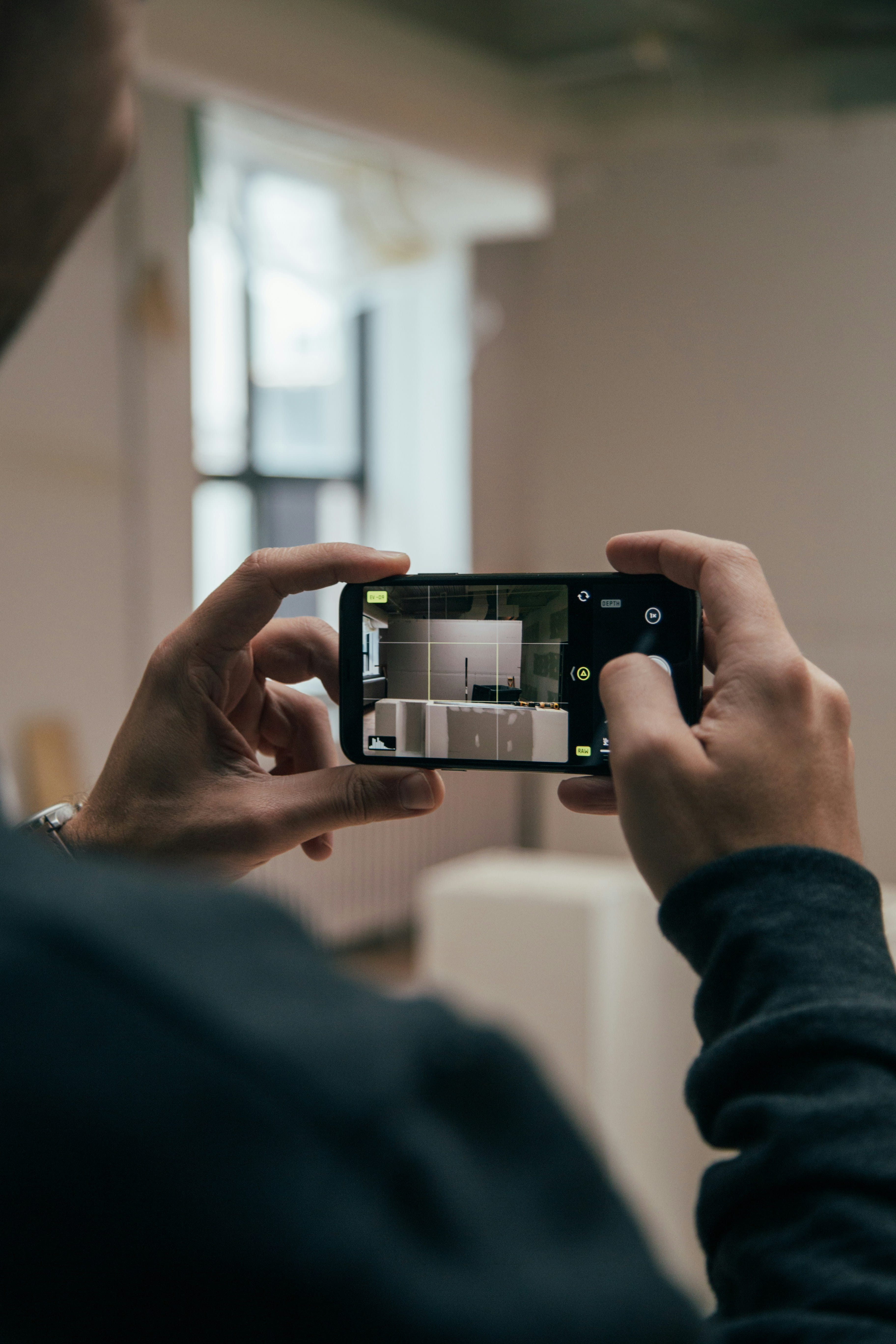 Painter taking a photo of the job on a phone