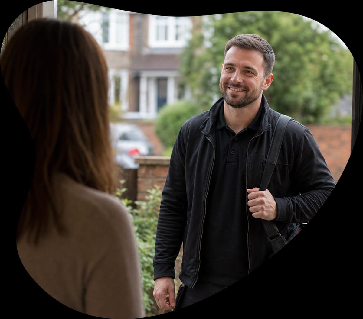 Tradesperson greeting a customer at the door
